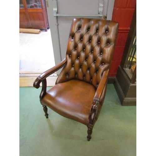 4196 - A Victorian style button back brown leather library armchair with brass stud decoration the scroll a... 