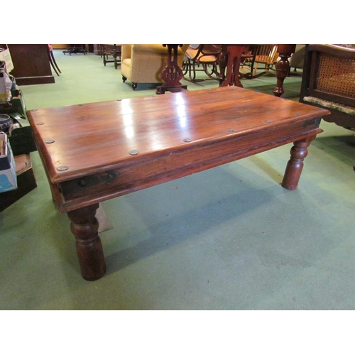 4231 - An Eastern hardwood coffee table with metal rivets, 60cm x 105cm x 40cm tall