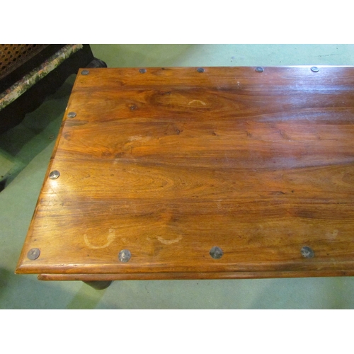 4231 - An Eastern hardwood coffee table with metal rivets, 60cm x 105cm x 40cm tall