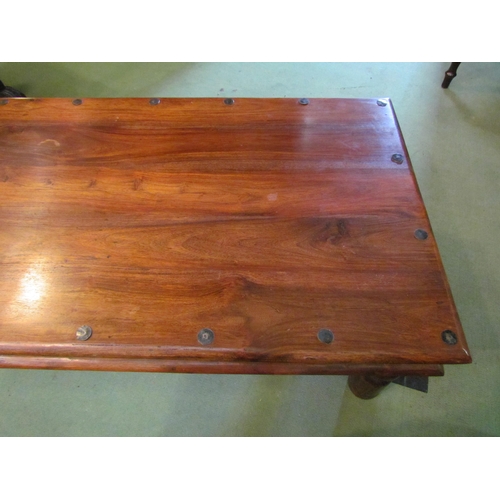 4231 - An Eastern hardwood coffee table with metal rivets, 60cm x 105cm x 40cm tall