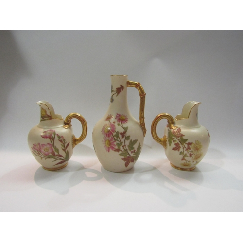 4275 - A pair of Royal Worcester Ewers (one restored lip) and a similar example (3)