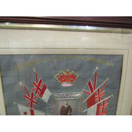 4009 - A needlework panel with central photograph of sailor surrounded by flags and Crown stitched commemor... 