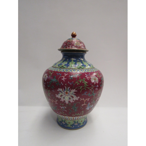 4076 - An early 20th Century Chinese polychrome lidded vase, painted with a foliate design on an ornate aub... 