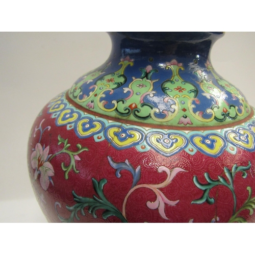 4076 - An early 20th Century Chinese polychrome lidded vase, painted with a foliate design on an ornate aub... 