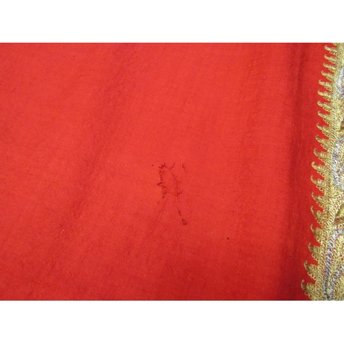 4180 - A late 19th Century Indian gold thread embroidered red felt shawl (worn)