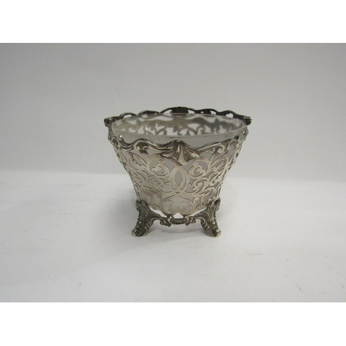 4341 - A silver pierced bowl on footed base and swing handle, with glass liner, 10cm tall, 13cm diameter