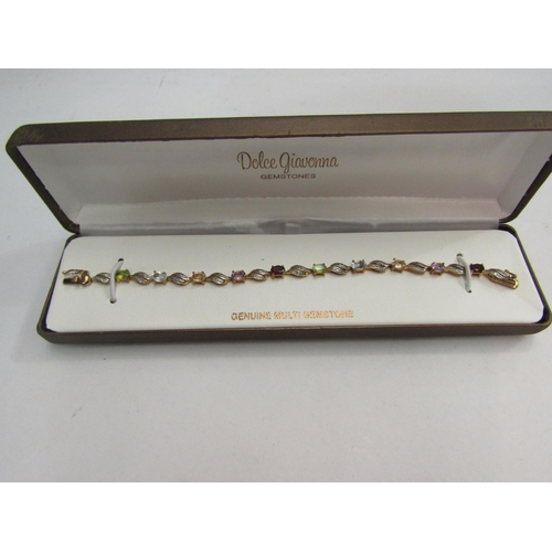 4379 - A silver plated bracelet with diamond chips and a yellow metal bracelet set with gemstones