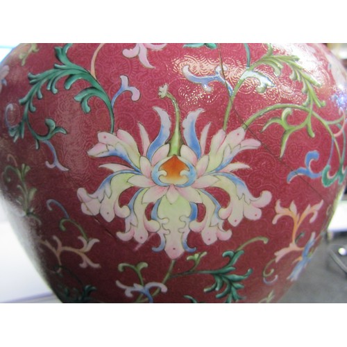 4076 - An early 20th Century Chinese polychrome lidded vase, painted with a foliate design on an ornate aub... 