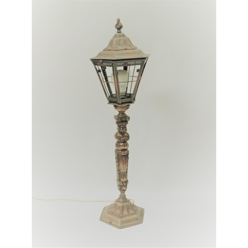 2123 - A cast copperized table lamp in the form of an old street light with scroll and mask detail, 70cm ta... 