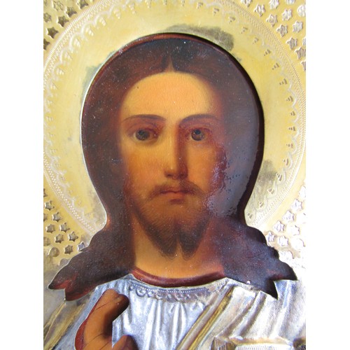 7130 - A 19th Century Russian Icon, oil on board with gilded and silvered metal relief moulding, gilded mou... 