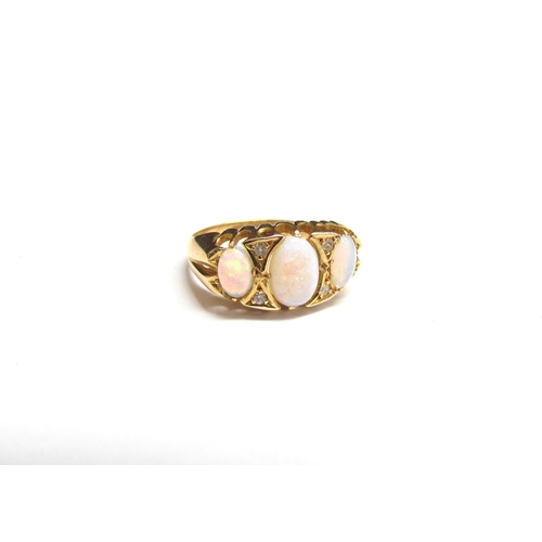 8036 - An 18ct gold opal and diamond ring. Size L, 3g   (R) £150