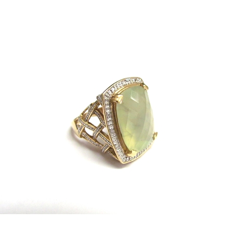 8068 - A 14ct gold prehnite and diamond ring, the central facet cut stone with diamond set basket weave sho... 