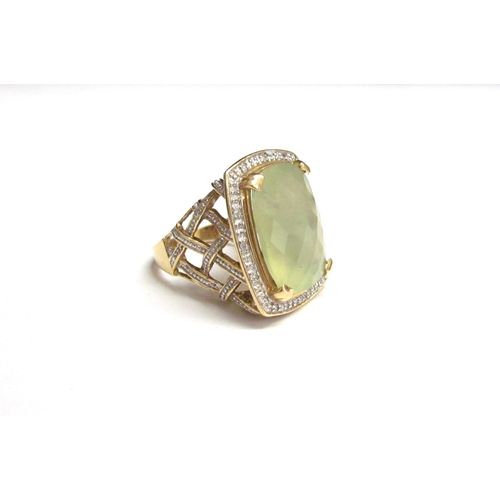 8068 - A 14ct gold prehnite and diamond ring, the central facet cut stone with diamond set basket weave sho... 