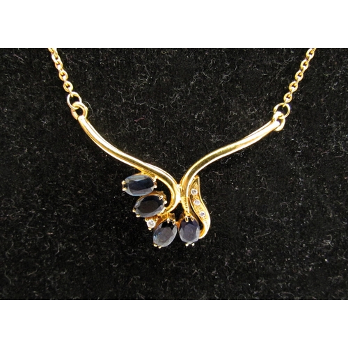 8057 - A gold neckchain having a scrolled bar set with four oval sapphires and four diamonds, stamped 750, ... 