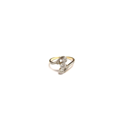 8054 - A gold ring with three North-South set diamonds in diamond set swirl shoulders, unmarked. Size G, 1.... 