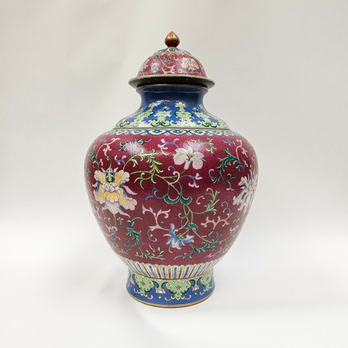 4076 - An early 20th Century Chinese polychrome lidded vase, painted with a foliate design on an ornate aub... 