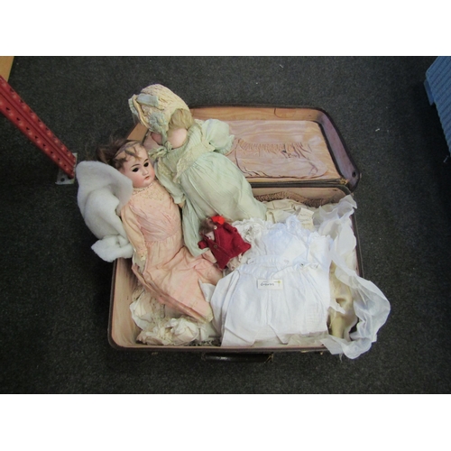 1234 - A suitcase containing bisque headed dolls to include Armand Marseille, some a/f