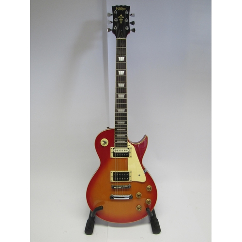 7343 - A Vintage Les Paul copy electric guitar in sunburst finish, with stand and soft case