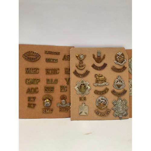 9108 - Four boards of British badges including shoulder titles, Scottish regimental cap badges etc