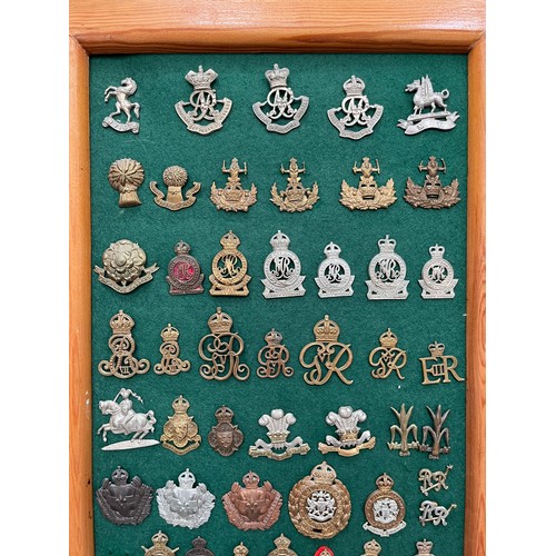 9153 - A display board of mainly yeomanry cap badges including Queen’s Own Oxfordshire Hussars, North Irish... 