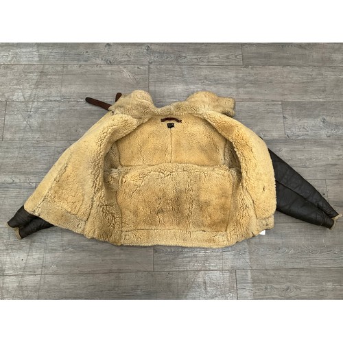 9077 - A WWII B3 sheepskin flying jacket by Perry Sportswear Co., with artwork to back, some wear requiring... 