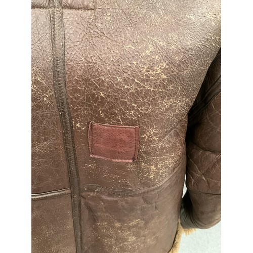 9076 - A WWII British Irvin sheepskin flying jacket, size 4, latch repairs present   (C)
