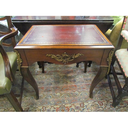 4087 - A Louis XIV walnut and rosewood small writing table, the gilt tooled leather writing surface over sq... 