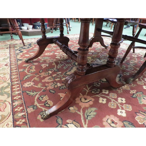 4100 - An early 19th Century flame mahogany sofa table the rising leaves over two frieze drawers on turned ... 