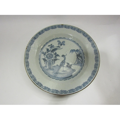 4099 - A Delft charger of bird and floral design, circa 1740, 30cm diameter