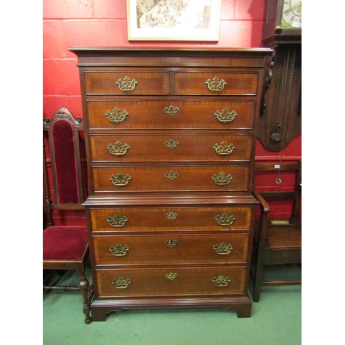 4132 - A George III style crossbanded mahogany tallboy of seven graduating long drawers over bracket feet, ... 