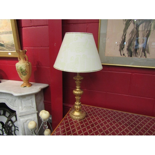 4143 - A gilt table lamp with shade, 74cm tall