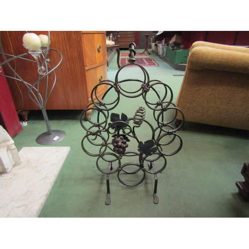 4147 - A wrought iron wine rack with grape and vine decoration, 62cm tall