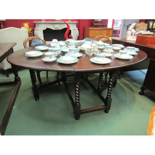 4161 - A large 18th Century revival oak oval top gate-leg dining table, the rising leaves over barley-twist... 