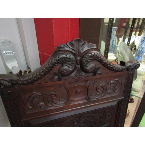 4162 - A Victorian 'Wainscot' armchair with carved mythical creatures having an acanthus leaf and fruit in ... 