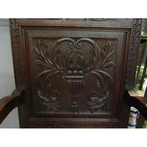 4162 - A Victorian 'Wainscot' armchair with carved mythical creatures having an acanthus leaf and fruit in ... 