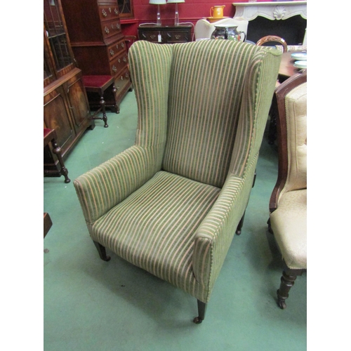 4169 - A circa 1930 wingback fireside armchair upholstered by 