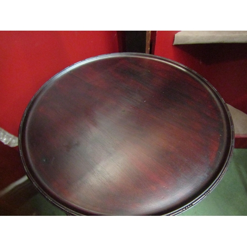 4175 - A George III style mahogany circular dish top wine table on a turned and fluted column with tripod b... 