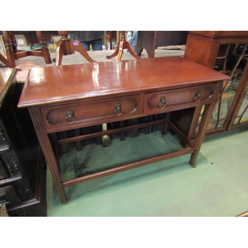 4197 - A Georgian mahogany serving table the two frieze drawers with brass lion-mask ring handles over carv... 