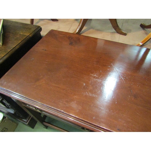 4197 - A Georgian mahogany serving table the two frieze drawers with brass lion-mask ring handles over carv... 