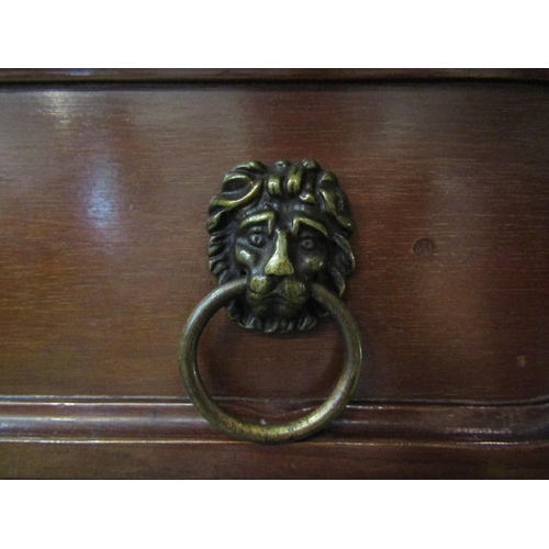 4197 - A Georgian mahogany serving table the two frieze drawers with brass lion-mask ring handles over carv... 