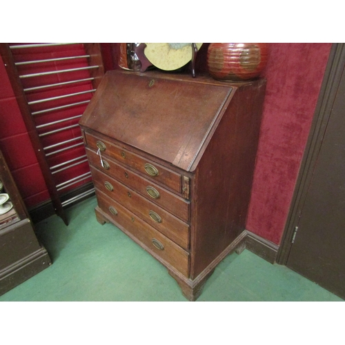 4185 - A George III oak bureau, the fall front over four graduating long drawers, bracket feet, 104cm tall ... 