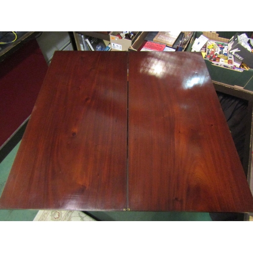 4001 - A circa 1840 mahogany table the fold-over hinged top on turned and tapering fluted legs, 76cm x 102c... 