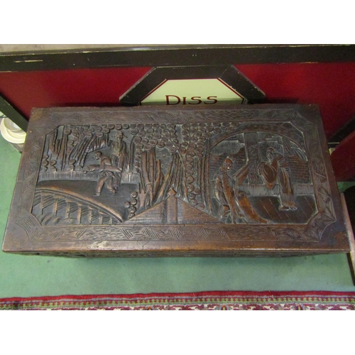 4015 - An Oriental hardwood blanket box on castors with heavily carved scenes, 55cm x 105cm x 51cm