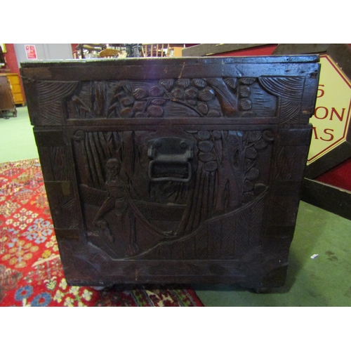 4015 - An Oriental hardwood blanket box on castors with heavily carved scenes, 55cm x 105cm x 51cm