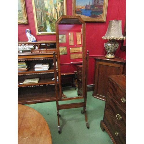 4040 - An Edwardian oak cheval mirror the canted corner mirror on ball finial supports over outswept legs a... 