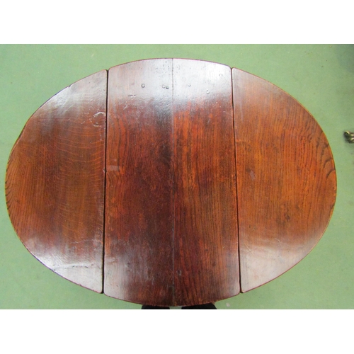 4062 - A 17th Century style pegged oak oval top occasional table/stool, the rising leaves over carved friez... 