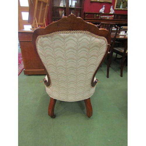 4070 - An Arts & Crafts oak open armchair with carved decoration over turned fore legs and ceramic castors