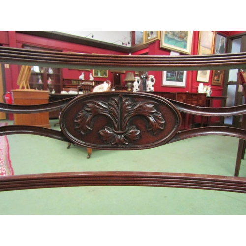 4096 - A Regency mahogany armchair with carved and fretwork cross splat the reeded arms on turned supports ... 