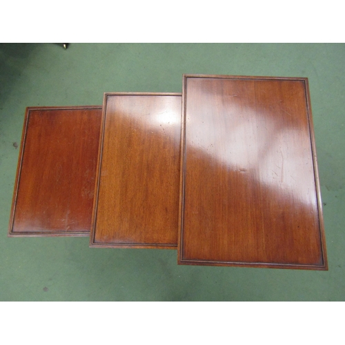 4156 - A nest of three George III style mahogany graduating occasional tables on ring-turned legs and sledg... 