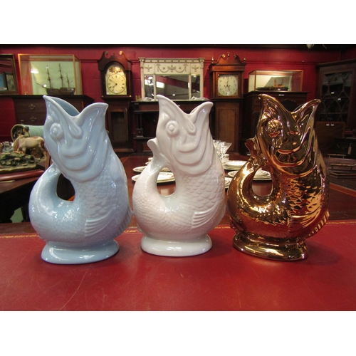 4176 - Three large Wade gluggle jugs of differing colours, 27cm tall